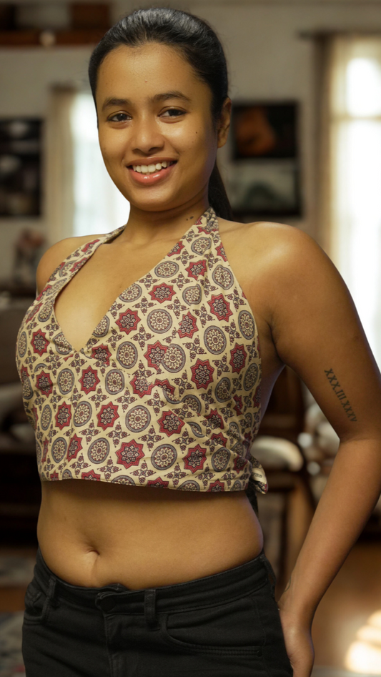 Woman wearing a patterned top in a living room setting
