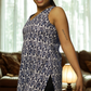 Woman wearing a patterned sleeveless top in a living room setting