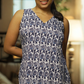 Woman wearing a blue and white patterned dress in a living room setting
