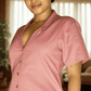 Woman wearing a pink shirt in an indoor setting